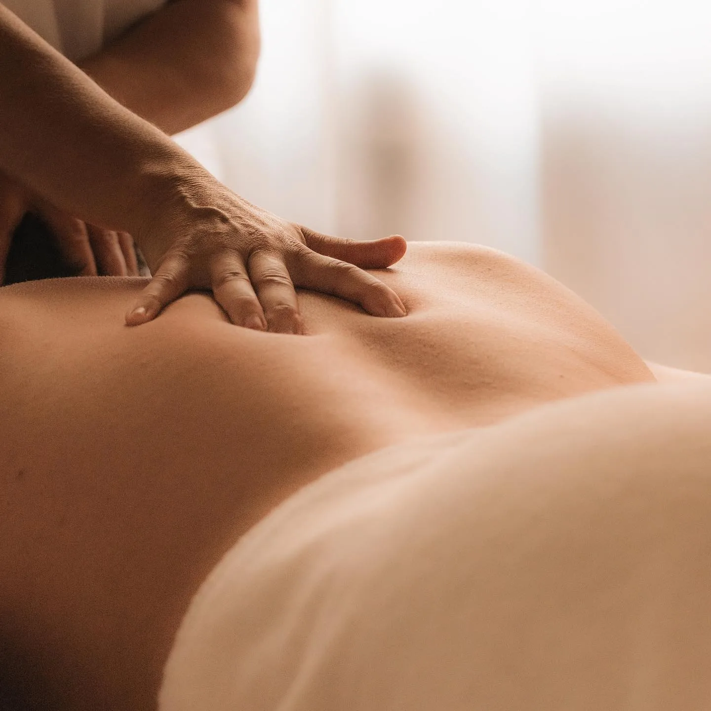 A therapist's hands during a back massage