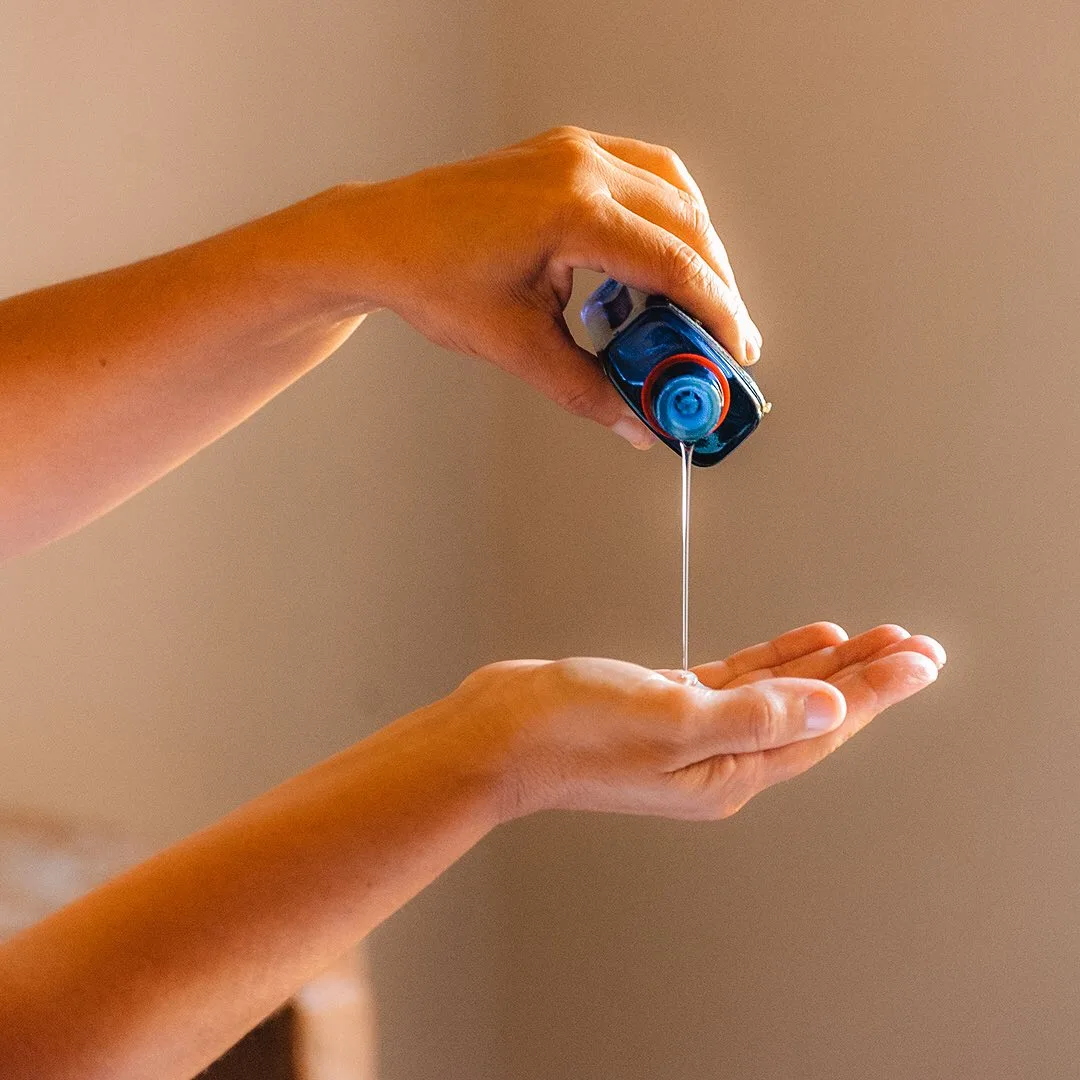 Massage oil falling onto the palm of a hand